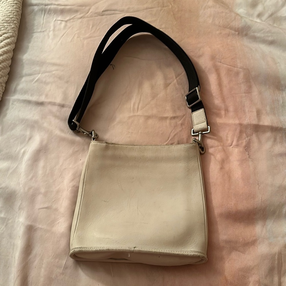 Coach white leather crossbody in fair pre-loved condition. Black canvas strap